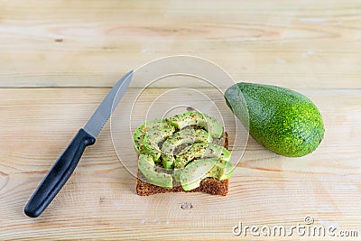 Beautifully rye toast bread with cut green avocado Stock Photo