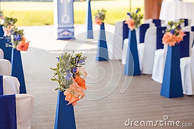 Beautifuly decorated with white and blue cloth and flowers chairs Stock Photo