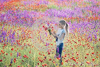 Beautiul caucasian girl holding big bouquet with poppies Stock Photo