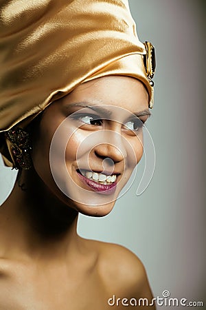 Beauty african woman in shawl on head, very elegant look with gold jewelry Stock Photo