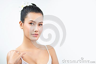 Beauty asian Woman face and Clean skin with Orchid on hair . close up beautiful girl smiling with makeup , cosmetic . portrait Stock Photo