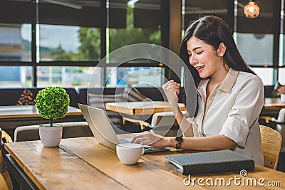 Beauty Asian woman having cheerful gesture after finishing job h Stock Photo