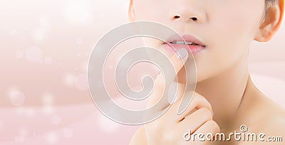 Beauty asian young woman with clean fresh skin touch lips. Stock Photo