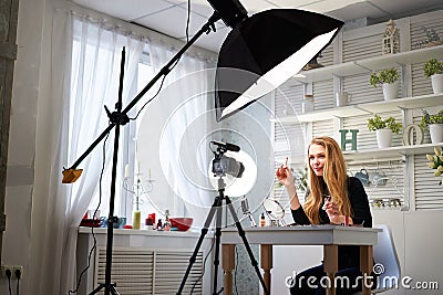 Beauty blogger woman filming daily make-up routine tutorial on camera. Influencer blonde girl live streaming cosmetics Stock Photo