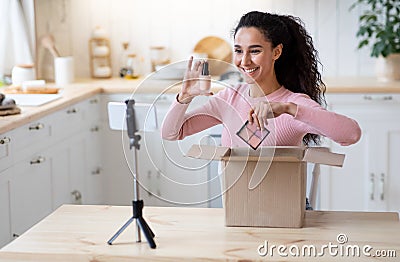 Beauty Blogging. Happy Attractive Lady Unboxing Parcel With New Cosmetics At Camera Stock Photo