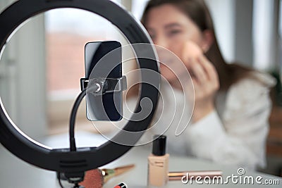 beauty blogging, technology and people concept portrait of a happy smiling girl blogger with ring light and smartphone applying Stock Photo