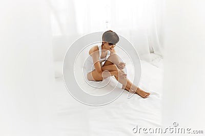 Beauty Body Woman. Beautiful Girl Touching Epilated Long Legs Stock Photo