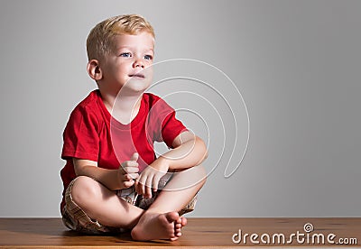 Beauty boy sitting on a table Stock Photo