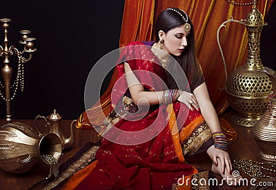 Beauty brunette Indian woman portrait. Hindu model girl with brown eyes. Indian girl in sari. Stock Photo