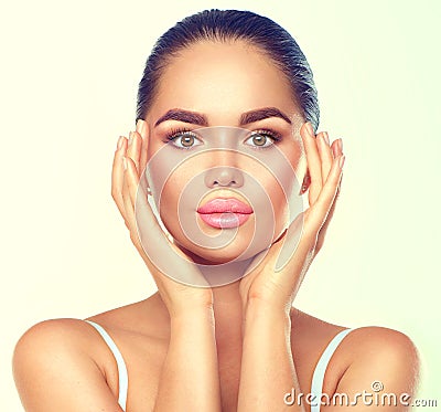 Beauty brunette spa woman with perfect makeup touching her face Stock Photo