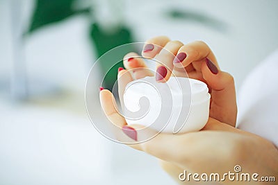 Beauty and Care. Girl Holding Face Cream. A Woman With Pure Skin Stock Photo