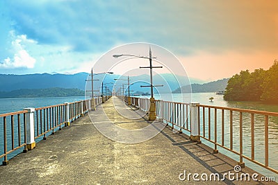 beauty cement bridge walkway on sea harbour. colorful sky over forest moutain in Island Stock Photo