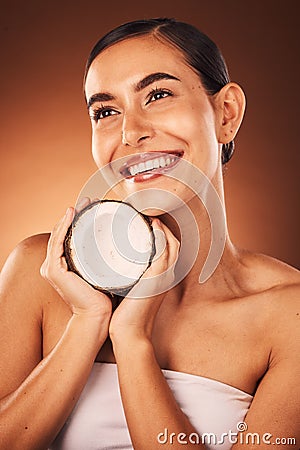 Beauty, coconut and skincare, woman with natural and diy facial product for face, body and skin against studio Stock Photo