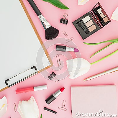 Beauty composition with clipboard, tulips, cosmetics and accessory on pink background. Top view. Flat lay. Home feminine desk. Stock Photo
