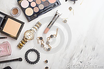 Beauty concept in a blog. Professional female make-up accessories, watch, bracelet, lipstick, brush, powder, on a marble Stock Photo