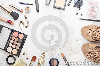 Beauty concept in a blog. Professional female make-up accessories, watch, bracelet, lipstick, brush, powder, on a marble Stock Photo