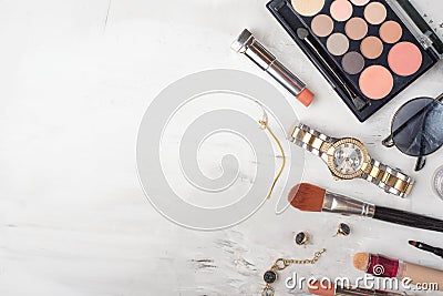 Beauty concept in a blog. Professional female make-up accessories, watch, bracelet, lipstick, brush, powder, on a marble Stock Photo