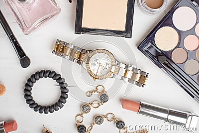 Beauty concept in a blog. Professional female make-up accessories: watches, bracelet, lipstick, brush, powder, on a marble Stock Photo