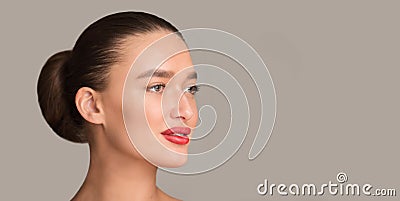 Beauty concept. Woman with plump red lips over grey background Stock Photo