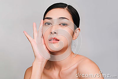 Beauty and Cosmetics Concept-Cloce up Youthful pretty young Asian woman with hand touching face on gray background Stock Photo