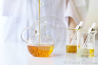 Beauty cosmetics sciences, Formulating and mixing skincare with herbal essence, Scientist pouring organic essential oil Stock Photo