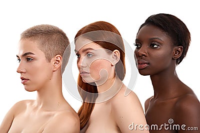 Beauty in Difference. Side view of three beautiful multicultural young women standing close to each other in studio Stock Photo