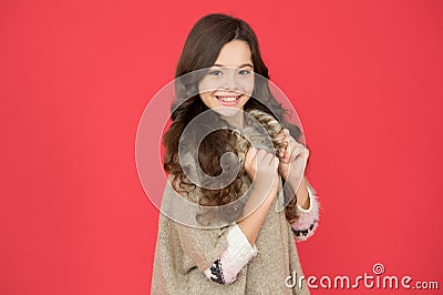 Beauty and elegance. little beauty smiling on red background. hairdresser concept. warm sweater for cold season. kid Stock Photo
