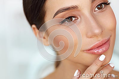 Beauty Face. Beautiful Woman Touching Lips With Lip Balm On Stock Photo