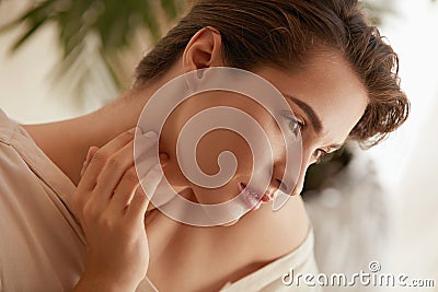 Beauty Face. Portrait Of Woman Touching Neck And Looking Away. Beautiful Model Enjoying Radiant And Glowing Facial Skin. Stock Photo