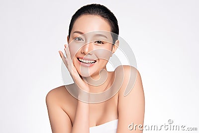 Beauty face. Smiling asian woman touching healthy skin portrait. Beautiful happy girl model with fresh glowing hydrated facial Stock Photo