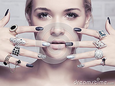 Beauty face.woman`s hands with jewelry rings Stock Photo