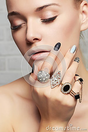 Beauty face.woman`s hands with jewelry rings Stock Photo