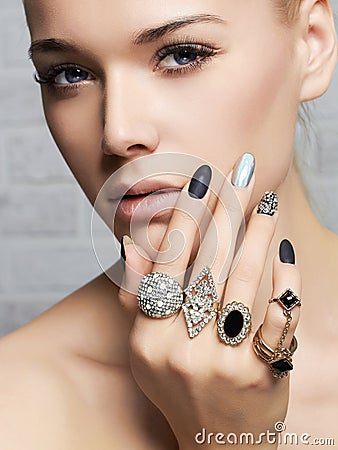 Beauty face.woman& x27;s hands with jewelry rings Stock Photo