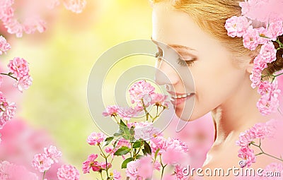 Beauty face of young beautiful woman with pink flowers in her ha Stock Photo