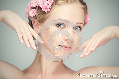 Beauty face of young beautiful woman with pink flowers Stock Photo