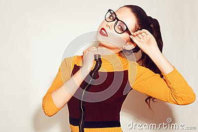 Beauty Fashion brunette model girl wearing stylish glasses. woman with perfect makeup, trendy orange and red dress Stock Photo