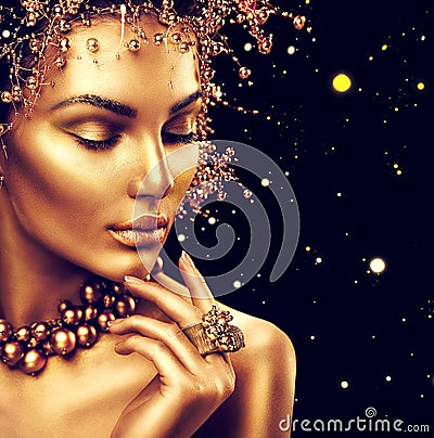 Beauty fashion model girl with golden skin, makeup and hairstyle Stock Photo