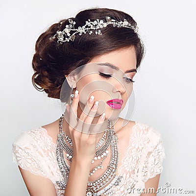 Beauty Fashion Model Girl with wedding elegant hairstyle. Beautiful bride woman with precious jewels, manicured nails. Makeup. Stock Photo