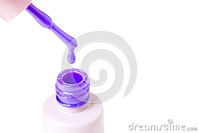 Beauty, fashion and Nail art concept. Manicure cosmetic tools close-up with bottle, brush and drop of purple gel nail polish. isol Stock Photo