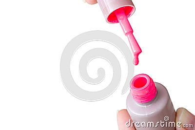 Beauty, fashion and Nail art concept. Manicure in nails spa salon -woman hands close-up with bottle, brush and drop of pink gel na Stock Photo