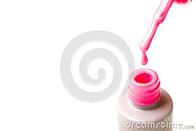 Beauty, fashion and Nail art concept. Manicure tools close-up bottle, brush and drop of pink gel nail polish. on white ba Stock Photo