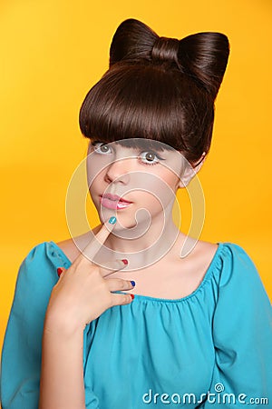 Beauty fashion teen girl with bow hairstyle and colourful manicu Stock Photo