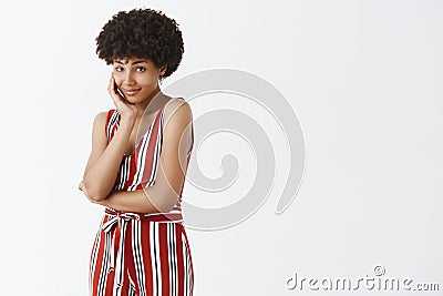 Beauty, feminine and fashion concept. Indoor shot of cute and tender African American woman with afro hairstyle leaning Stock Photo