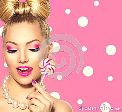 Beauty girl eating colourful lollipop Stock Photo