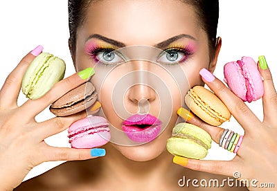 Beauty girl taking colorful macaroons Stock Photo