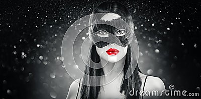 Beauty glamour brunette woman wearing carnival feather dark mask, party over holiday black background Stock Photo