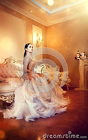Beauty gorgeous woman in beautiful evening dress in luxurious style interior room Stock Photo