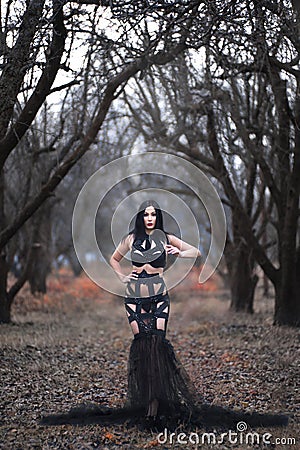 Beauty gothic woman in dress in the forest Stock Photo