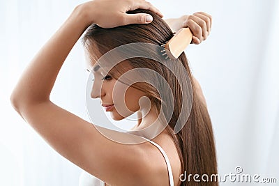 Beauty Hair Care. Beautiful Woman Brushing Long Healthy Hair Stock Photo