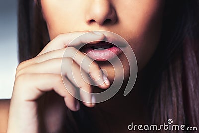 Beauty, hand and closeup of woman lips in studio for facial makeup routine with gloss. Cosmetic, beautiful and zoom of Stock Photo